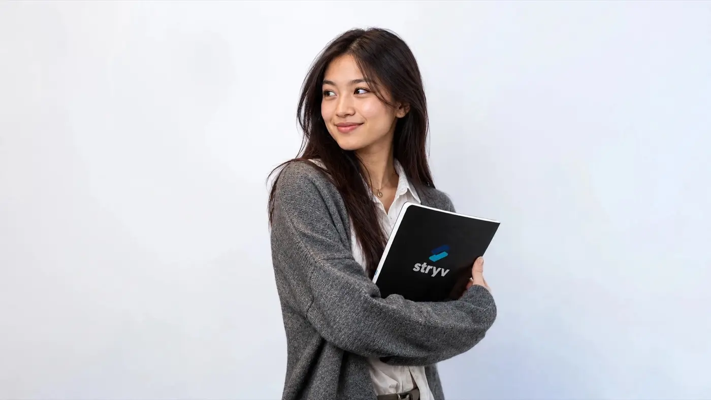 A Stryv tutor holding a Stryv notebook